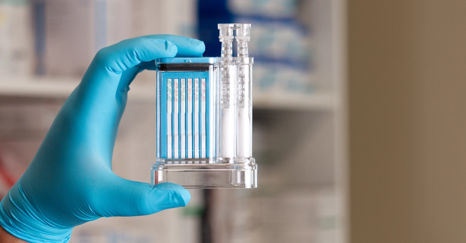 Gloved hand holding EZ Saliva-II™